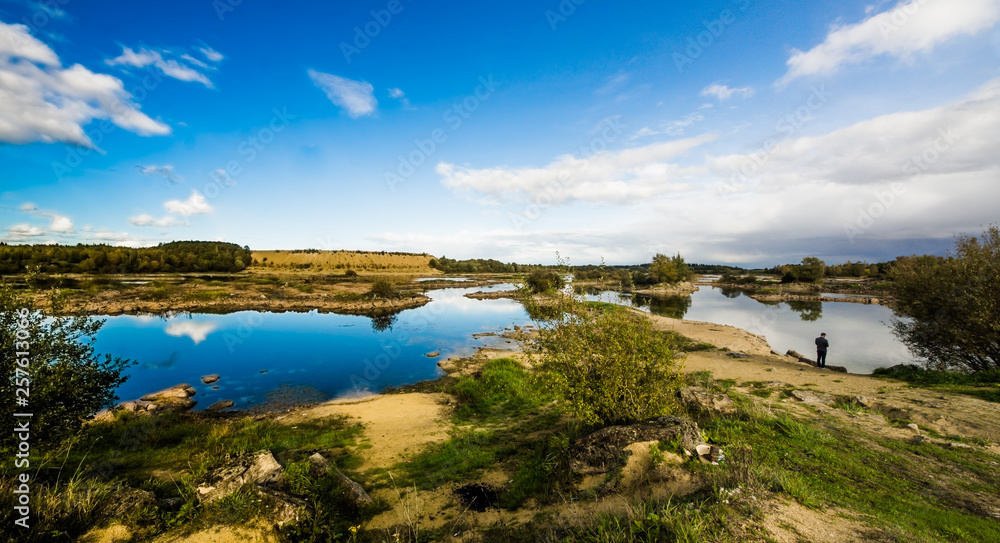 Sandy hills. Lake in the Sandy canyon. Warm colors background. Yellow sandstone textured mountain, white thin sand dune, bright sky. Sunshine landscape Sandy hills. Lake in the Sandy canyon. Warm colors background. Yellow sandstone textured mountain, white thin sand dune, bright sky. Sunshine landscape