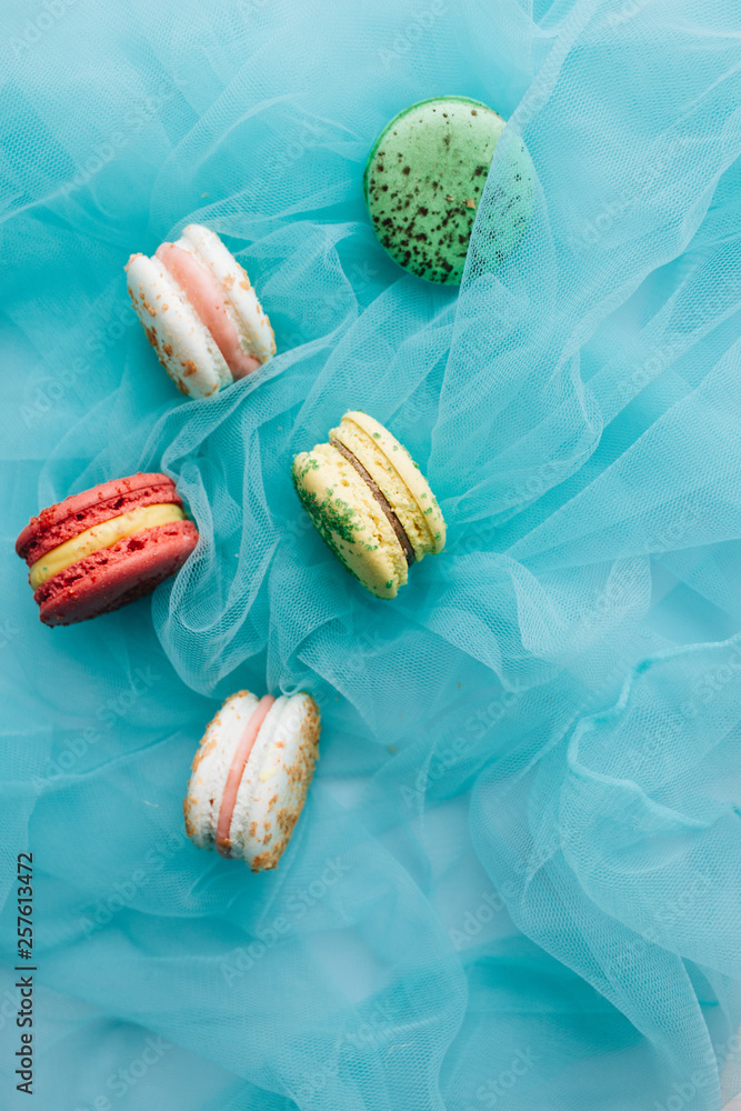 Composition of delicious macaroons on blue textile Composition of delicious macaroons on blue textile