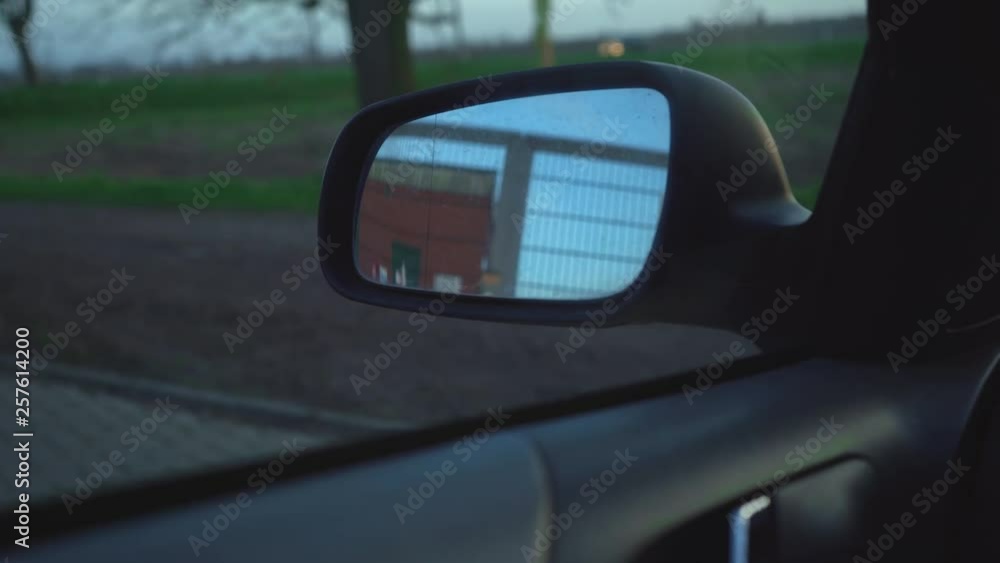 View through a car window with side mirror View through a car window with side mirror