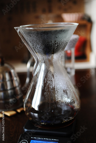 Black japonic porous ceramic paperless dripper filter in glass jug. Alternative manual coffee brewing. Gooseneck kettle photo