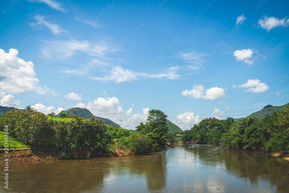 Blue sky high peak mountains fog hills mist scenery river lake dam bay gulf wildlife  National park views Kanchanaburi, Thailand.