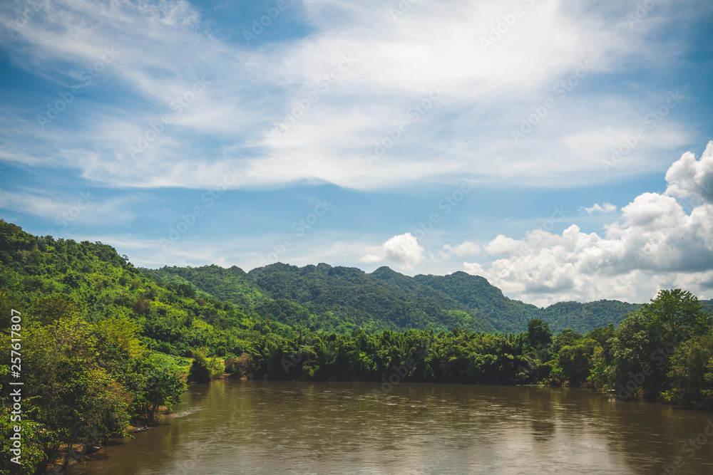 Blue sky high peak mountains fog hills mist scenery river lake dam bay gulf wildlife  National park views Kanchanaburi, Thailand.