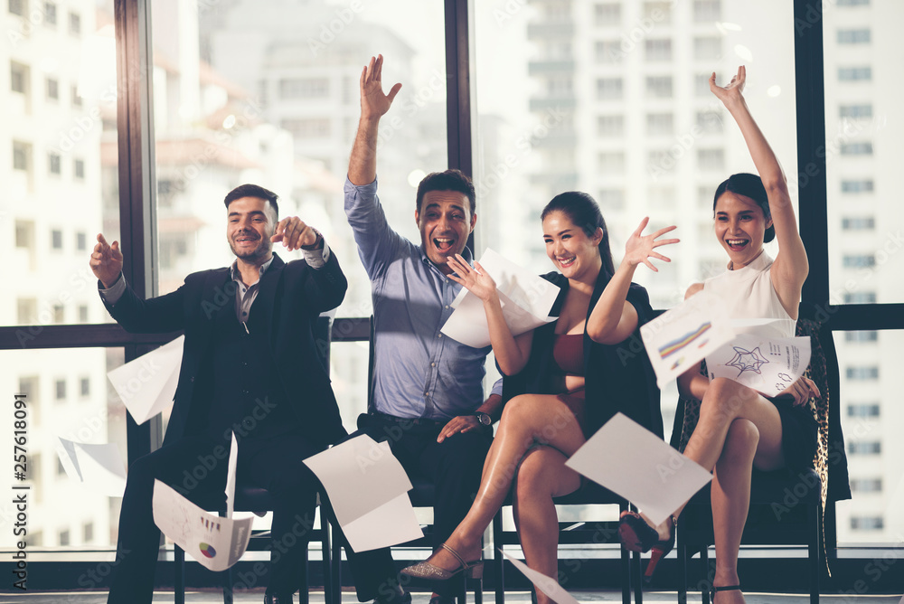 Naklejka premium Group of business people celebrating by throwing their business papers in the air