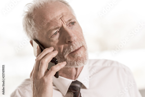 Senior businessman talking on mobile phone