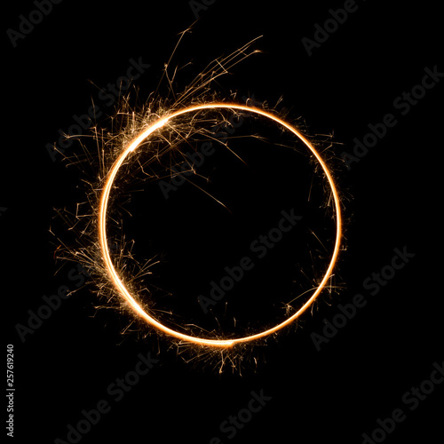 Sparkler circle shape. Burning bengal fire round letter o number zero, long exposure.