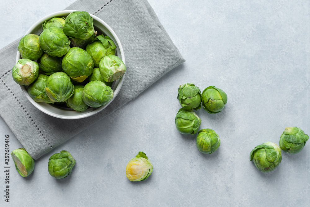 Fresh Brussels sprouts on a light gray concrete background Fresh Brussels sprouts on a light gray concrete background