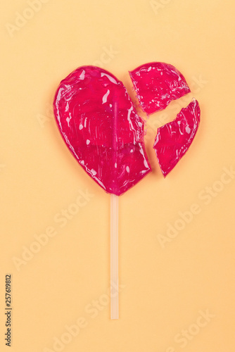Принти на полотні Broken lollipop candy heart love shape on yellow background