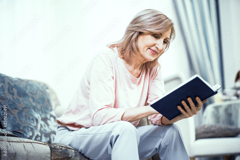 Middle Aged Woman Sitting On Sofa And Reading Bible Middle Aged Woman Sitting On Sofa And Reading Bible