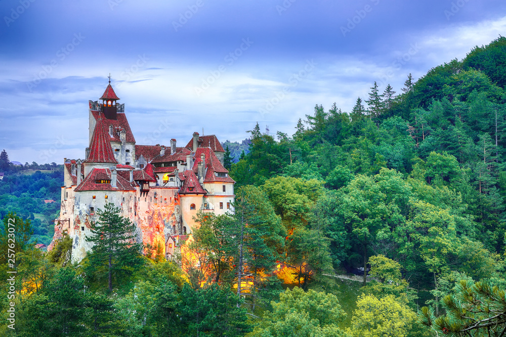 Landscape with medieval Bran castle known for the myth of Dracula at sunset
