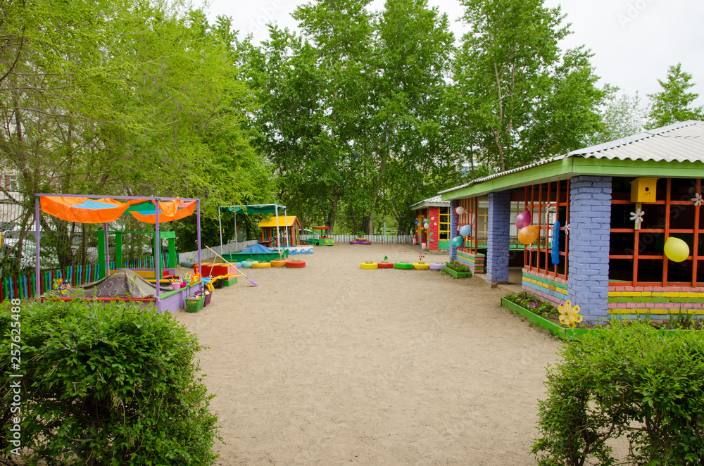 playground with a veranda, flower beds and game structures