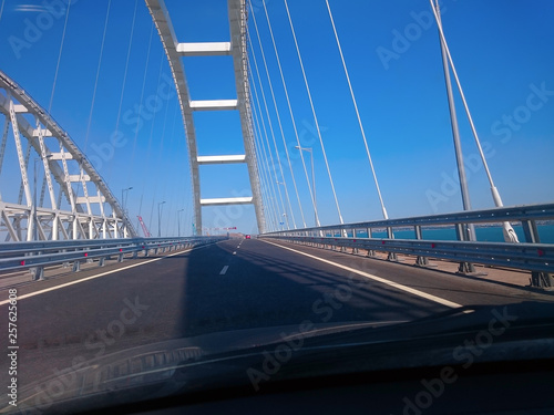 View through the windshield of a moving car. Crimea, Russia - June, 8, 2018: Travel on the Crimean bridge during its construction. View from the car