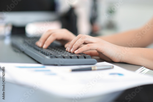 Closeup of a female hands busy typing on a laptop