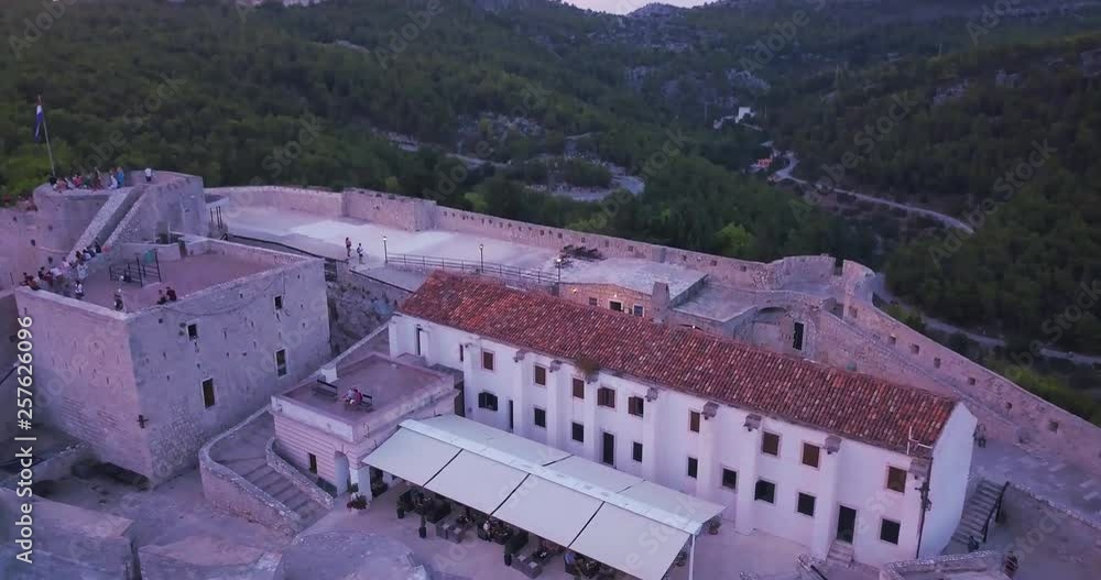 Aerial tilt flying over Spanjola fortress at sunset, hill top historic fort surrounded by Hvar landscape, Croatia Aerial tilt flying over Spanjola fortress at sunset, hill top historic fort surrounded by Hvar landscape, Croatia