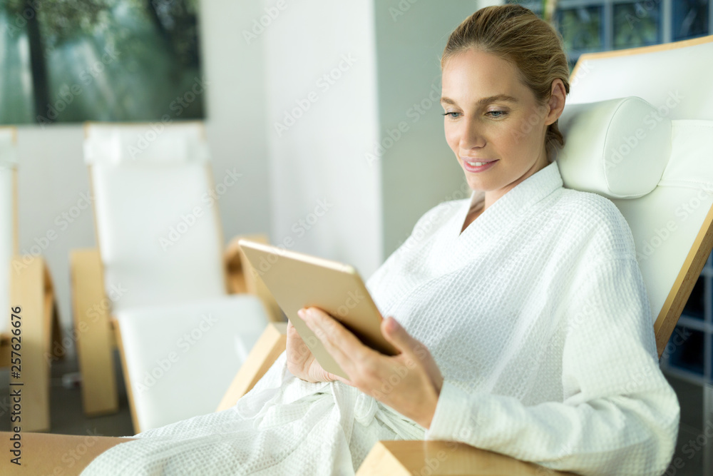 Beautiful woman relaxing and using tablet in spa Beautiful woman relaxing and using tablet in spa