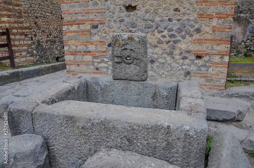 Fototapeta Naklejka Na Ścianę i Meble -  Roman ruins of Pompeii with remains of a fountain
