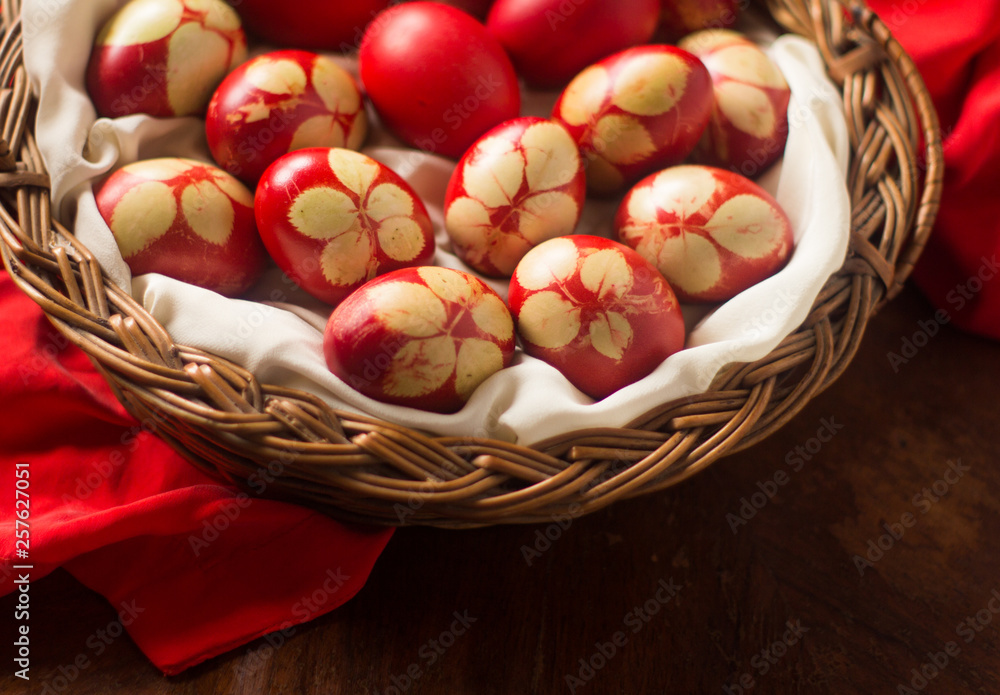 Traditional red Easter eggs with rose leaf, in basket on wood background. Traditional red Easter eggs with rose leaf, in basket on wood background.