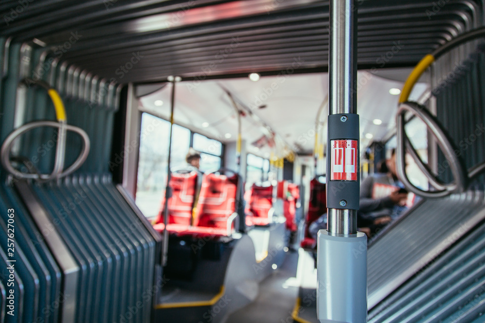 Interior of a public transport bus and stop Button in a bus, blurry background