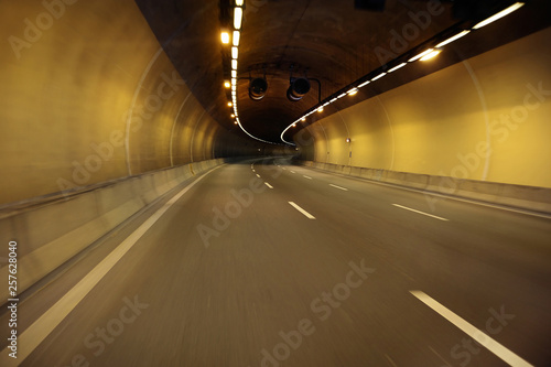 Empty highway road at night tunnel with speed motion blur