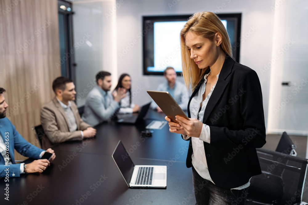 Attractive businesswoman using digital tablet in office Attractive businesswoman using digital tablet in office
