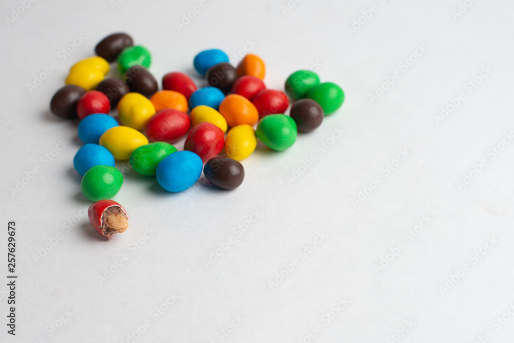 Colorful chocolate candies on the white background Colorful chocolate candies on the white background