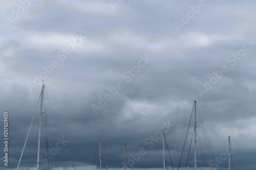 Sail posts against a grey cloudy sky