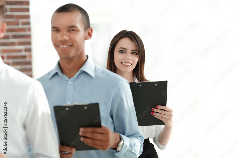 group of business people with business papers,standing in the office group of business people with business papers,standing in the office