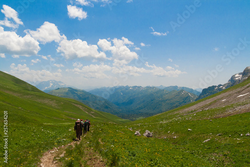 Wallpaper Mural A few of tourists walking along the trail in the mountains. Torontodigital.ca
