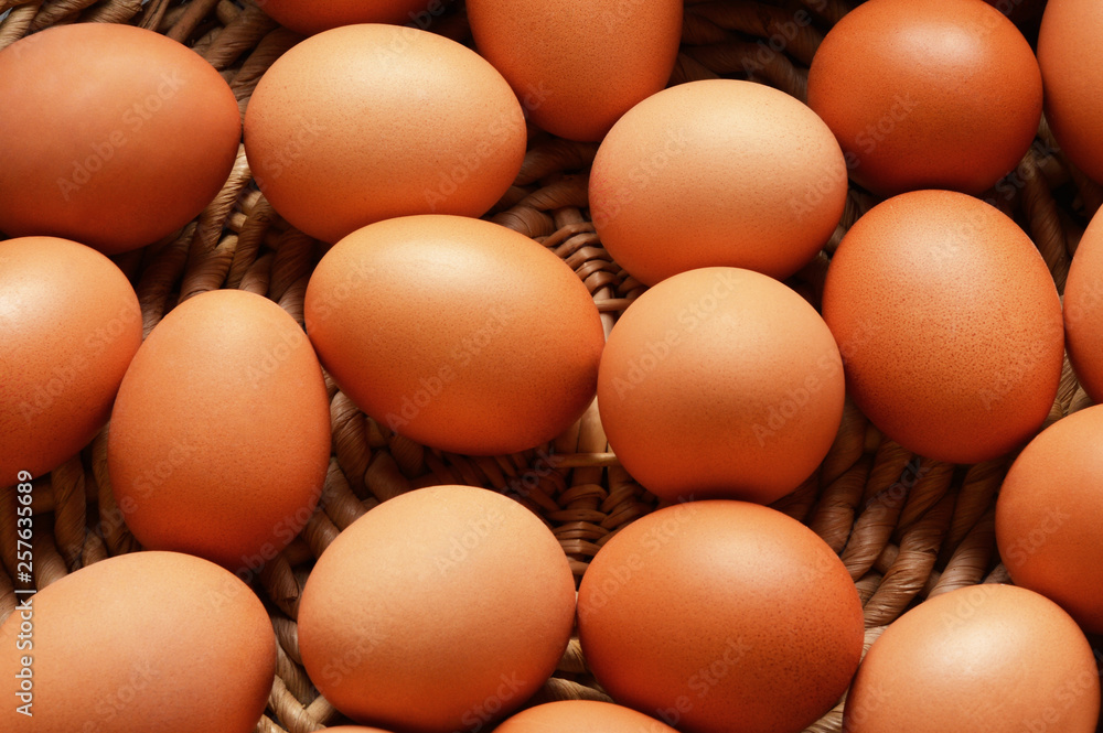 Brown eggs on a wicker basket background