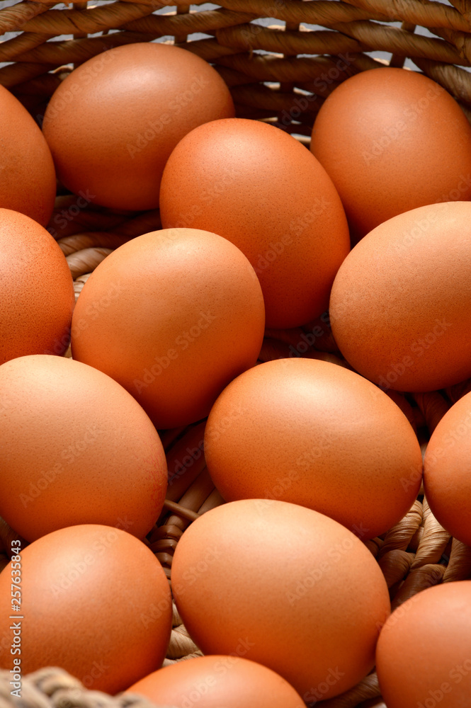 Brown eggs on a wicker basket background Brown eggs on a wicker basket background
