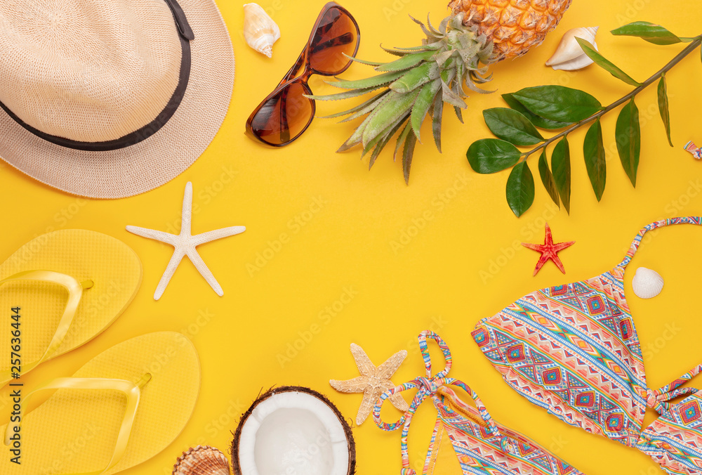 Summer vacation, travel, tourism concept flat lay. Tropical beach accessories top view with swimming suit, hat and flip flops Summer vacation, travel, tourism concept flat lay. Tropical beach accessories top view with swimming suit, hat and flip flops