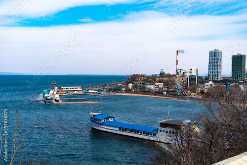 Vladivostok, Russia - 24 March, 2019: View of the city embankment and amusement park photo