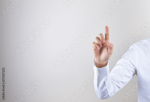 Businessman touching imaginery screen photo