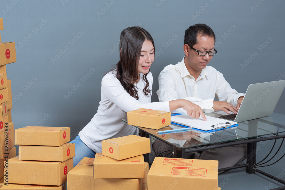 Men and women are helping to pack the boxes. Men and women are helping to pack the boxes.
