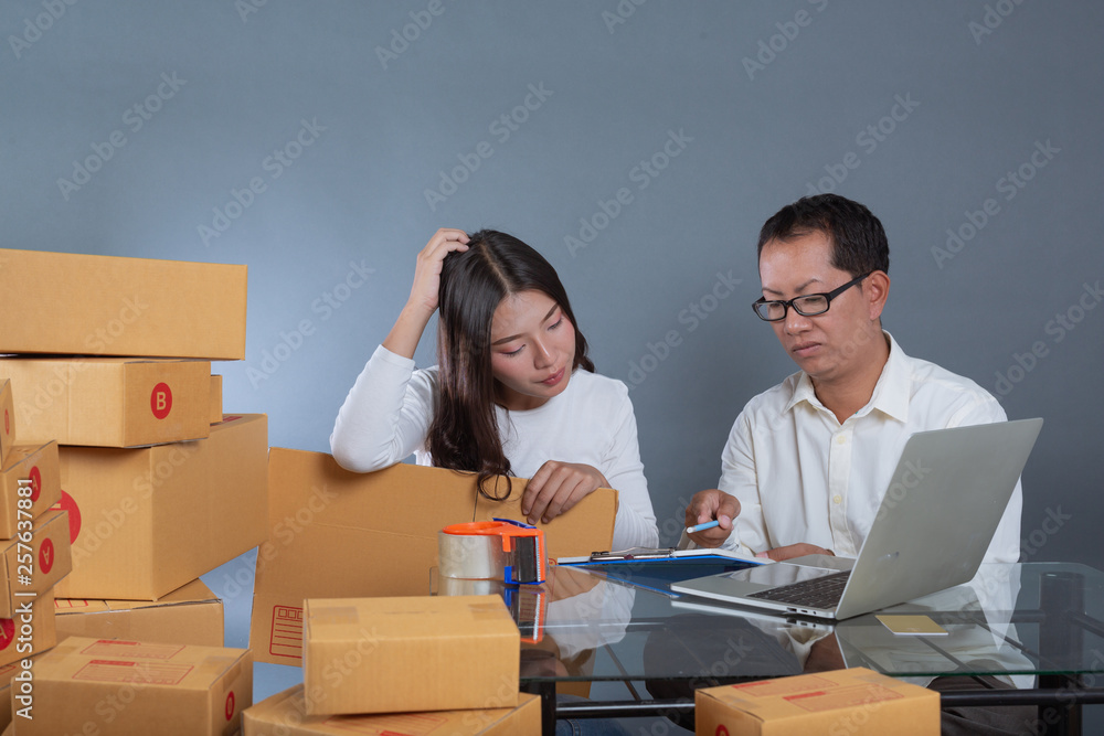 Men and women are helping to pack the boxes. Men and women are helping to pack the boxes.