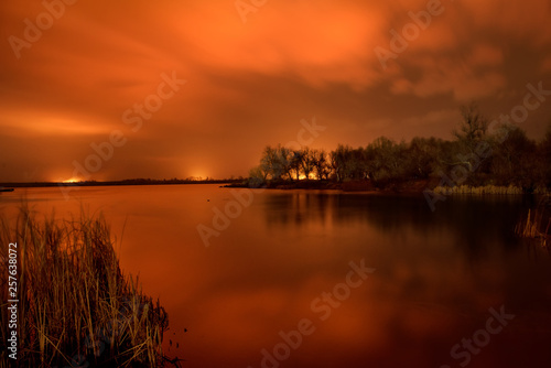 Fire in the floodlands on the river. Night photo. Dnieper River Delta.