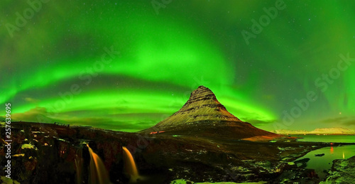View of the northern light at night at Kirkjufell Mountain in Iceland.