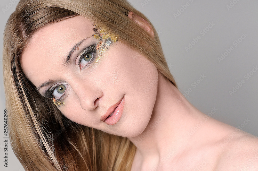 Smiling beautiful woman with make-up looking at the viewer with attention Smiling beautiful woman with make-up looking at the viewer with attention