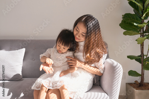 Happy young mother with daughter at home
