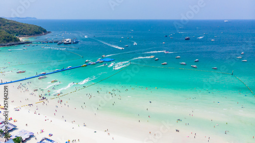 Aerial view tropical beach with group of people playing in turquoise ocean water and waves, Top view Soft wave of emerald clear sea of paradise island © AU USAnakul+