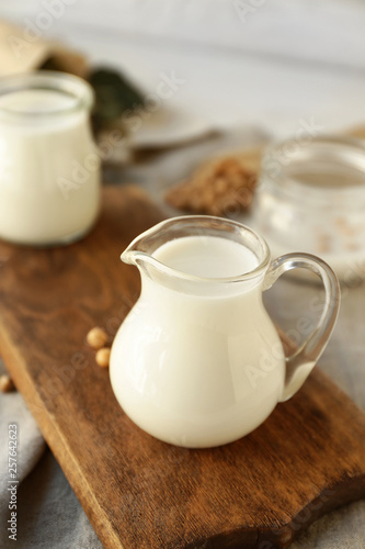 Jug of healthy soy milk on table