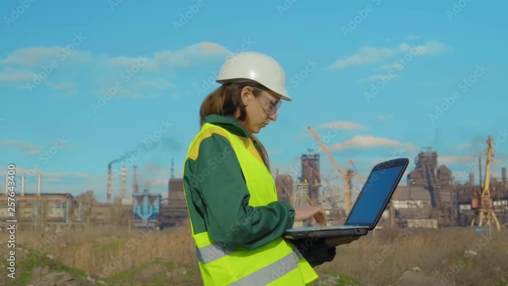The young female engineer, worker at work location works The young female engineer, worker at work location works