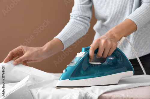 Woman ironing clothes at home