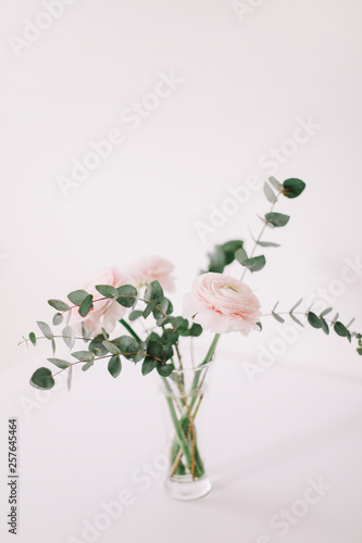 Pink ranunculus on white background. Romantic background for wedding invitations and greeting cards. Floral composition. Flatlay  copy space. 