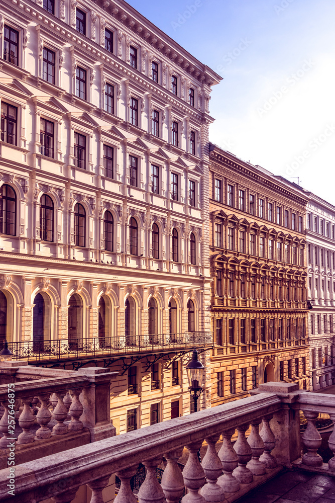 Austria, Vienna: Beautiful front view of typical apartment historical building facades in the city center of the austria capital illuminated by late afternoon sun light - concept architecture living