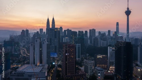 4K Cinematic Sunrise Zoom In Time Lapse Footage of Kuala Lumpur city skyline from the west side of the Malaysian capital.