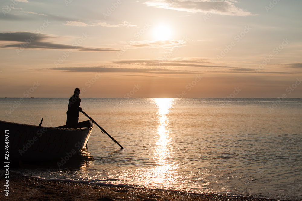 Fishing boat silhouette at sunrise