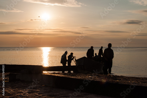Fishermen in a boat at sunrise