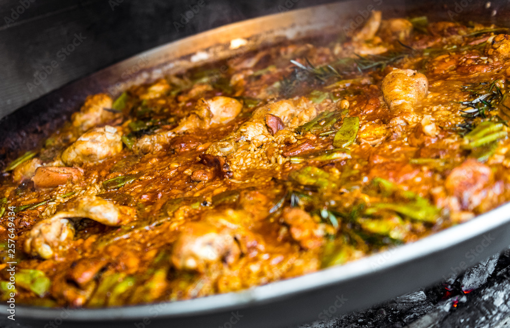 Cooking and making a traditional Spanish Paella over open fire. Cooking and making a traditional Spanish Paella over open fire.