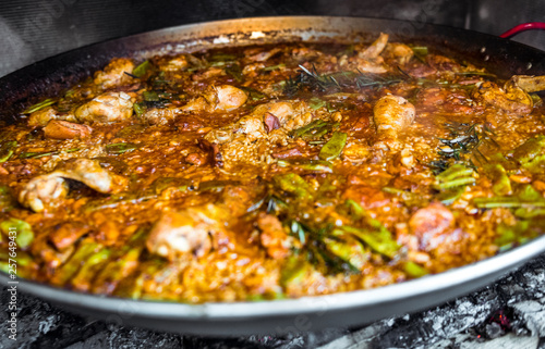 Cooking and making a traditional Spanish Paella over open fire. © _jure