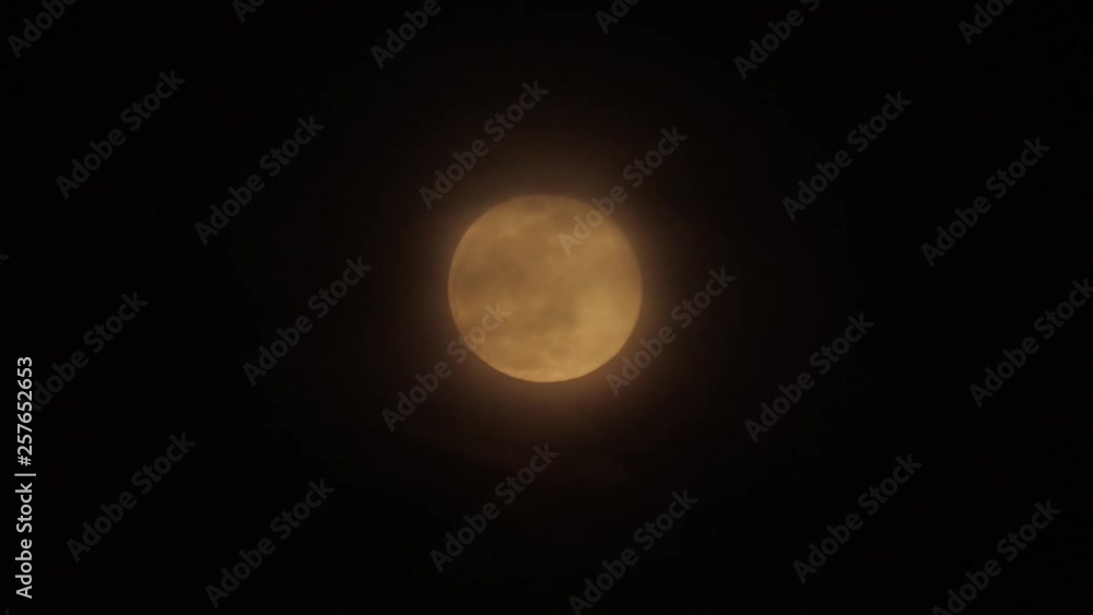 Full moon in cloudy sky, black clouds covering the moon in accelerated camera Full moon in cloudy sky, black clouds covering the moon in accelerated camera